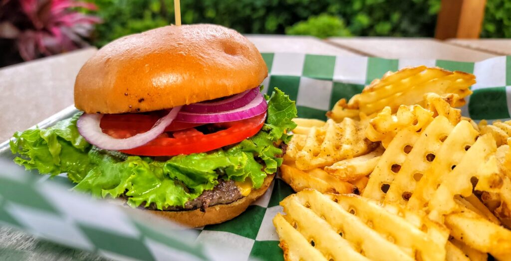 Classic Angus Cheeseburger topped with cheese, green leaf lettuce, tomato, red onion served on a toasted bun with waffle french fries.  CW Willis Family Farms on Oslo Road in Vero Beach, Florida.