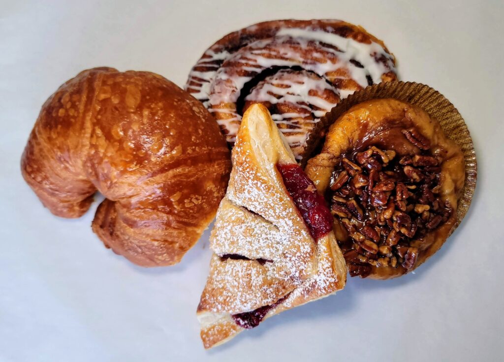 Fresh Baked Goods - Butter Croissant, Cherry Turnover, Pecan Sticky Bun, and Cinnamon Roll from Cravings in Vero Beach Florida