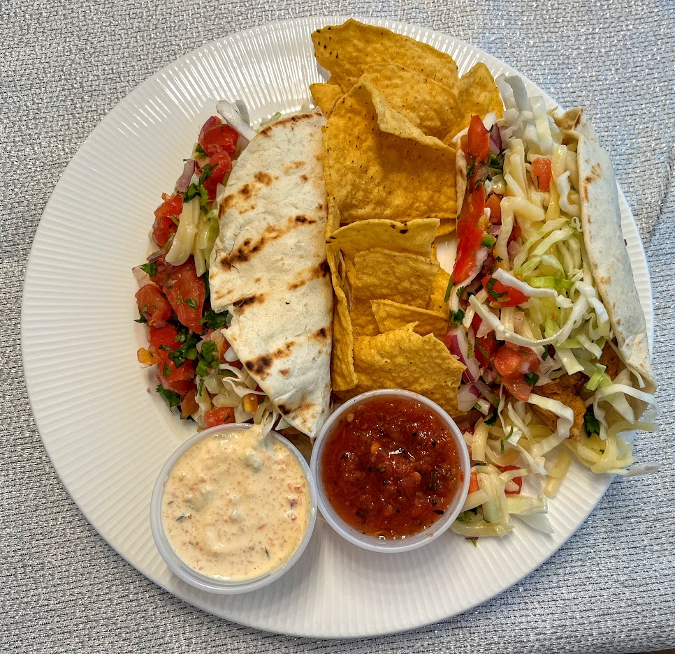Flash-fried haddock with white cheddar cheese, cabbage, pico de Gallo, and tarter creme fresh in flour tortillas from Dinner Revolution Vero Beach