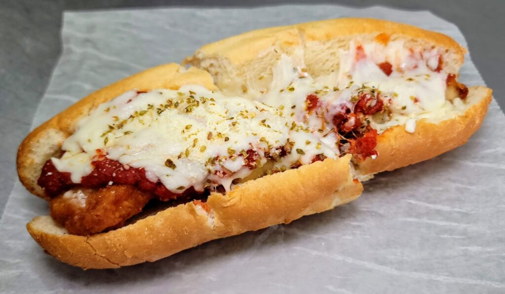 Ty's Deli in Vero Beach Florida off 20th street Chicken Pizzaiole - Crispy fried breaded chicken cutlets, tomato basil pizza sauce, mozzarella cheese, parmesan cheese, and oregano, on a toasted hoagie roll.