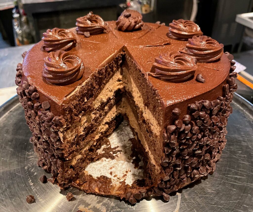 Decadent Chocolate Layer Cake with a Chocolate Mousse Center at Sandy's Grille in Sebastian, Florida, a rich and delicious dessert made with layers of chocolate cake and a creamy chocolate mousse center.