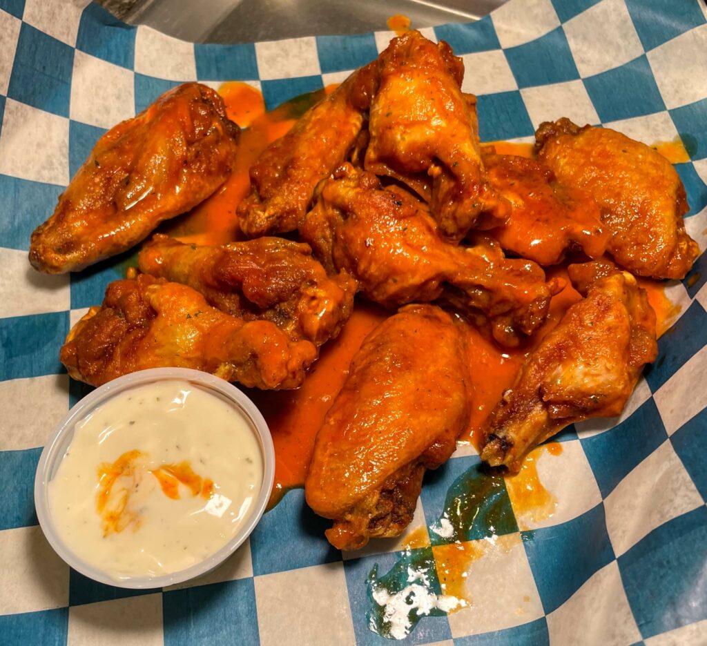 Sandy's Awesome Mild Ranch Wings at Sandy's Grille in Sebastian, Florida, a perfect appetizer or entree for wing lovers, with a mild flavor and ranch dressing for dipping.