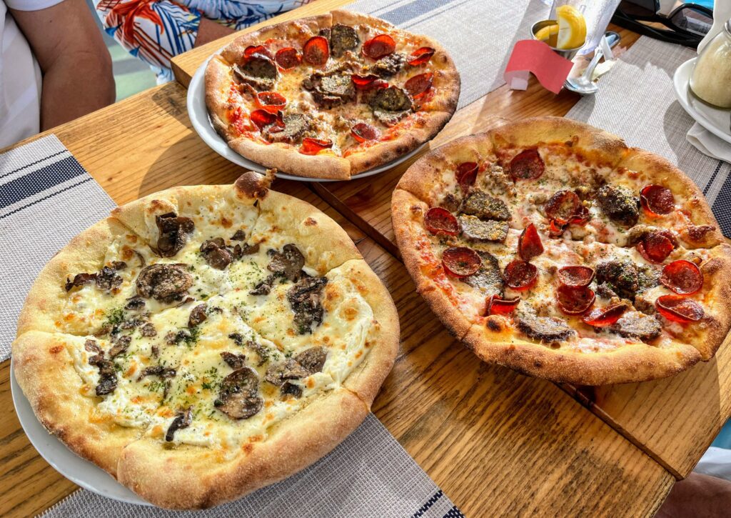 A delicious pizza with a white truffle bianchi sauce and a variety of toppings,  Perfect for pizza lovers who want to enjoy a unique and flavorful pizza experience