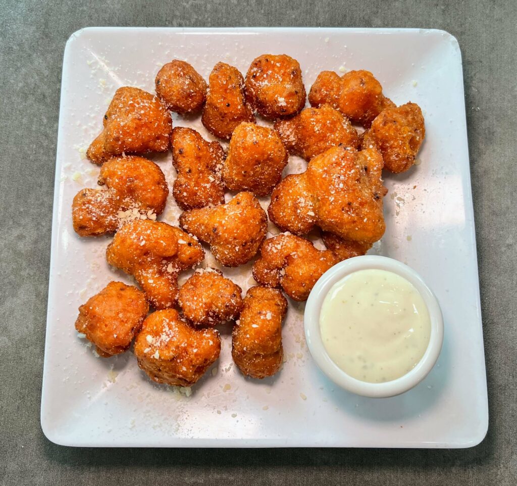 Cauliflower Bites - The cauliflower is tossed in a mild buffalo sauce after being lightly breaded, and it was served with Ranch dressing for dipping. Vittorio's Pizza in Vero Beach, FL on Oslo Road