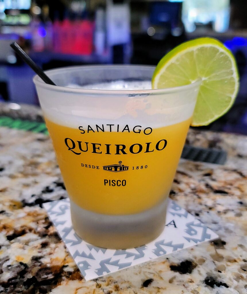 a passionfruit pisco sour cocktail from Ceviche 28, a Peruvian restaurant located in Vero beach, Florida