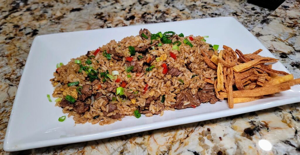 Chaufa, a fusion of peruvian and chinese fried rice served on a plate at Ceviche 28, a Peruvian restaurant located in Vero beach, Florida