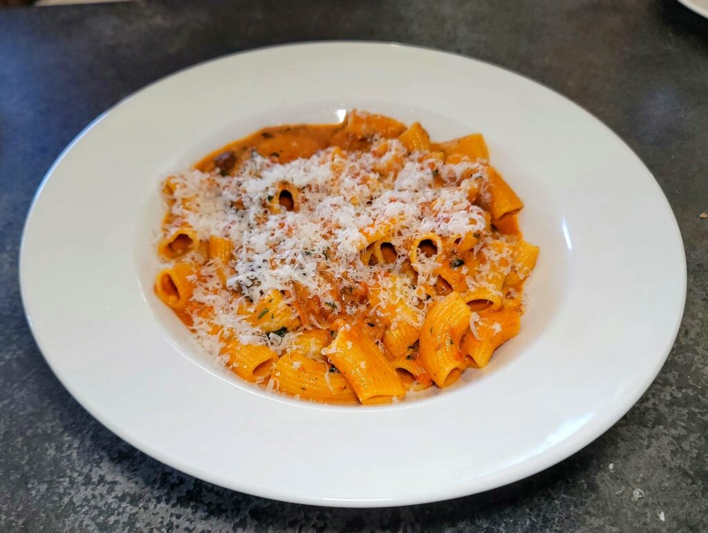 FRESH HOUSE-MADE RIGATONI - This soul-satisfying dish is a veal and braised beef bolognese with tiny mushrooms, carrots, and parmigiano reggiano at City Cellar Wine Bar & Grill in the Square in West Palm Beach Florida