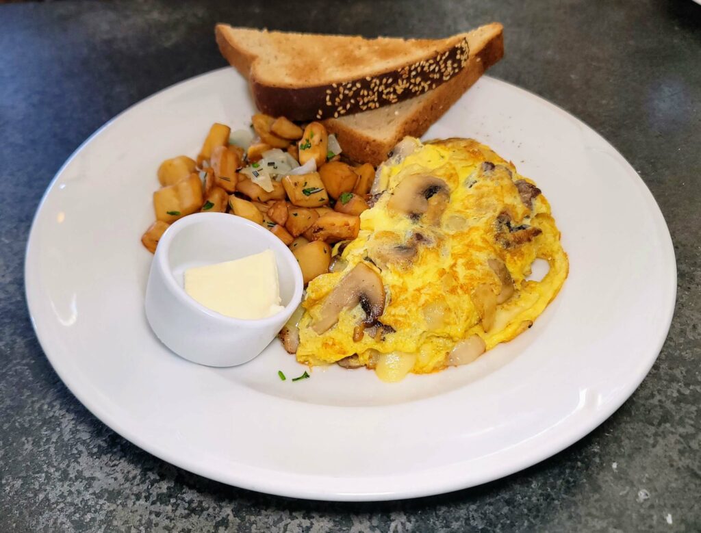 OMELETE OF THE DAY featuring steak, mushrooms, onions, and cheese at City Cellar Wine Bar & Grill in the Square in West Palm Beach Florida