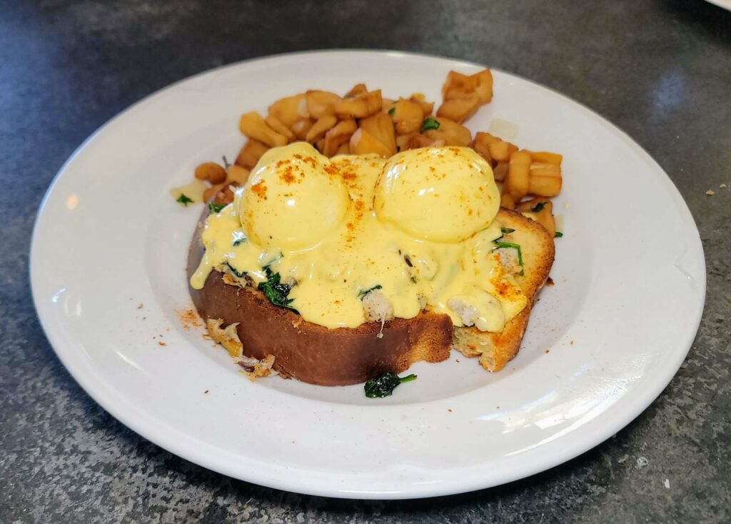 BLUE CRAB FLORENTINE ON BRIOCHE - With spinach, poached eggs, breakfast potatoes, and old bay hollandaise at City Cellar Wine Bar & Grill in the Square in West Palm Beach Florida