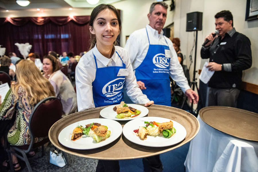 a hospitality student carries a try of food to hungry diners that attended the treasure coast masterchef competition at the indian river state college mueller campus in vero beach florida