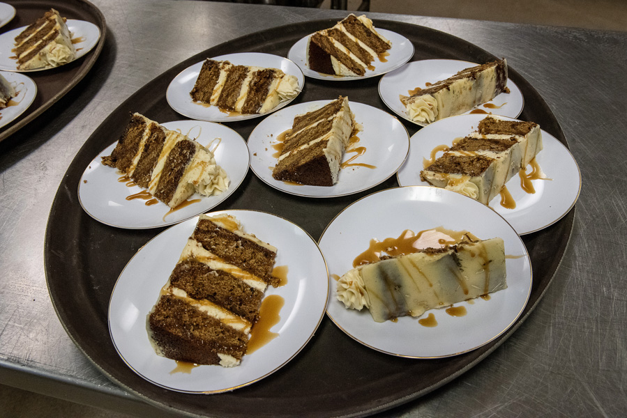 8 small dessert plates with a sticky toffee pudding cake slice before being delivered to guests attending the treasure coast masterchef competition on the indian river state college mueller campus in vero beach florida