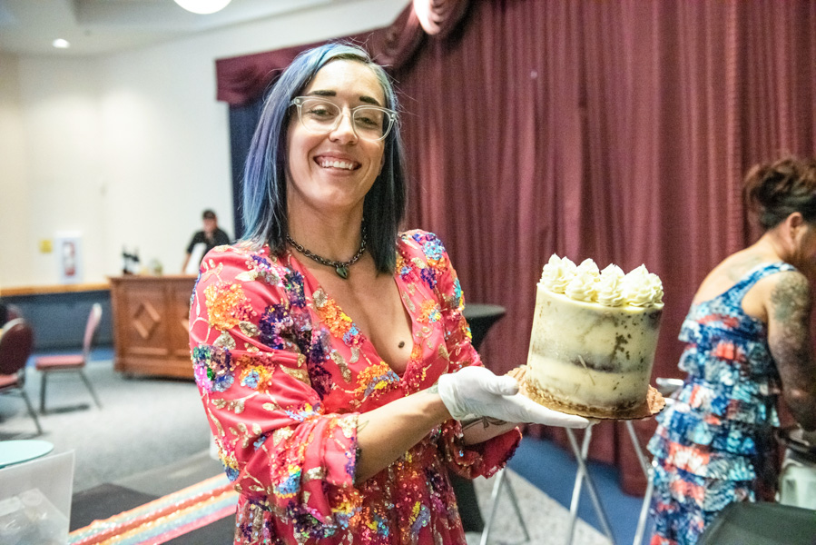 Brittany O'Leary of Cake & Crescent holds up one of her Sticky Toffee Pudding cakes she created as the dessert course for the treasure coast masterchef competition on th eIndian River State college mueller campus in vero beach florida
