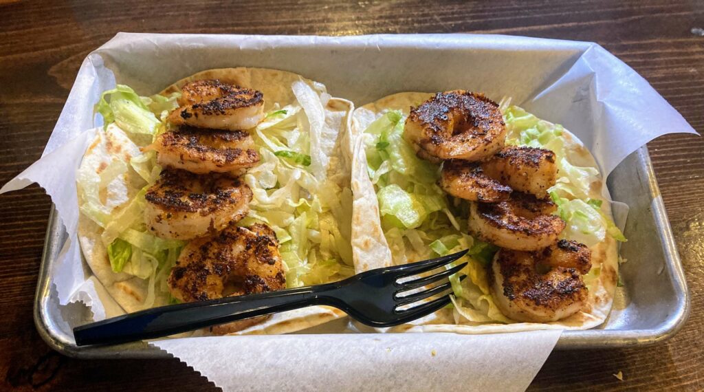two blackened shrimp tacos served on a metal tray from taco dive downtown fort pierce location on the treasure coast of florida