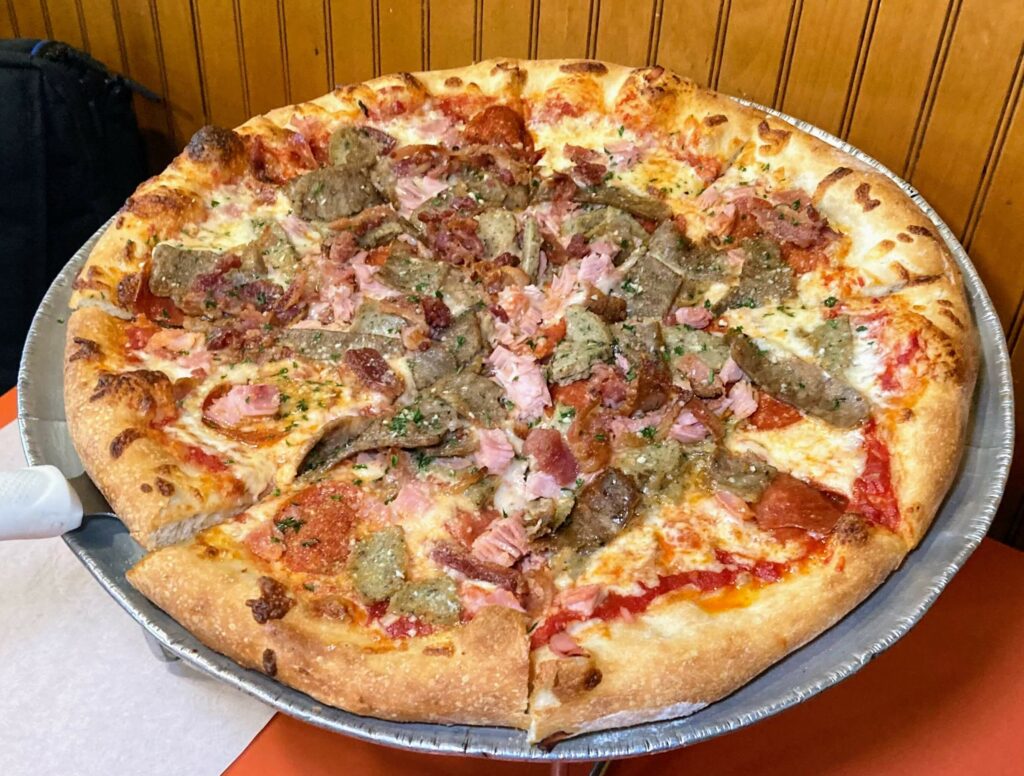 a medium meat lovers pizza from cap's pizza and pub in vero beach florida