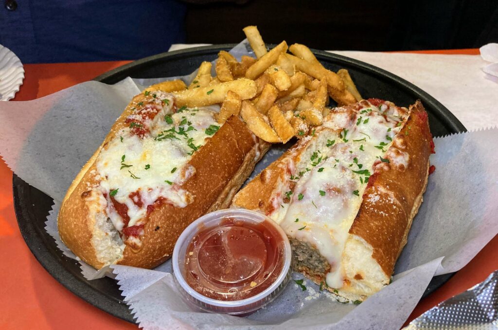 meatball sub sandwich served with french fries and a side of marinara sauce from cap's pizza and pub located in vero beach florida