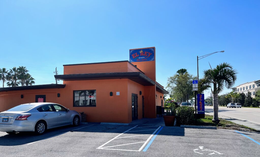 side view of el rey mexican restaurant and parking lot in vero beach florida