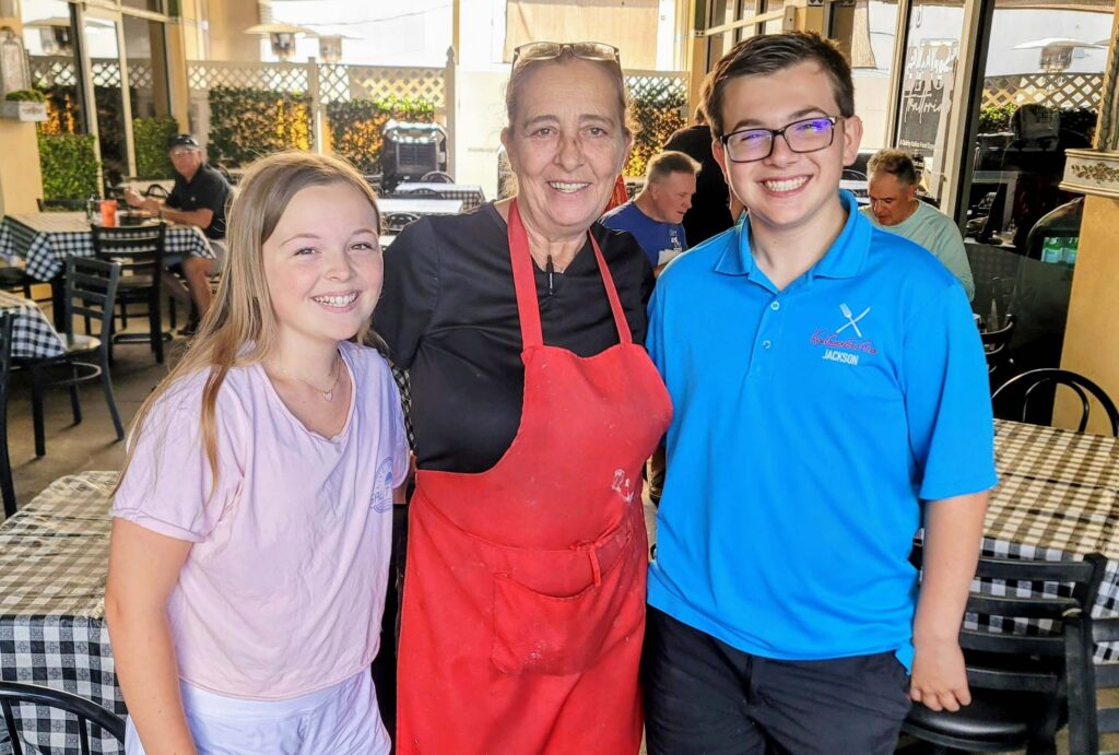 In this photo is Lilly Harbin, Emi Fulchini, and Jackson Harbin on the outside patio at Baci Trattoria located in Downtown Vero Beach Florida