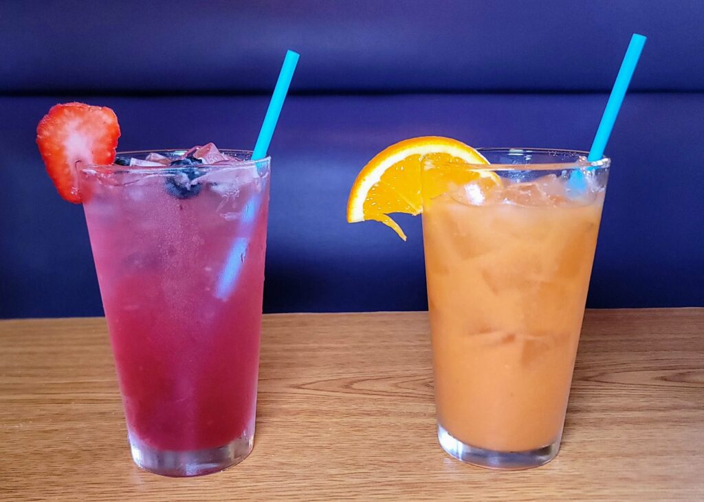 Two drink glasses with summertime special drinks, Very Berry Lemonade and Sunshine Punch, at Berry Fresh Cafe located in Stuard Florida