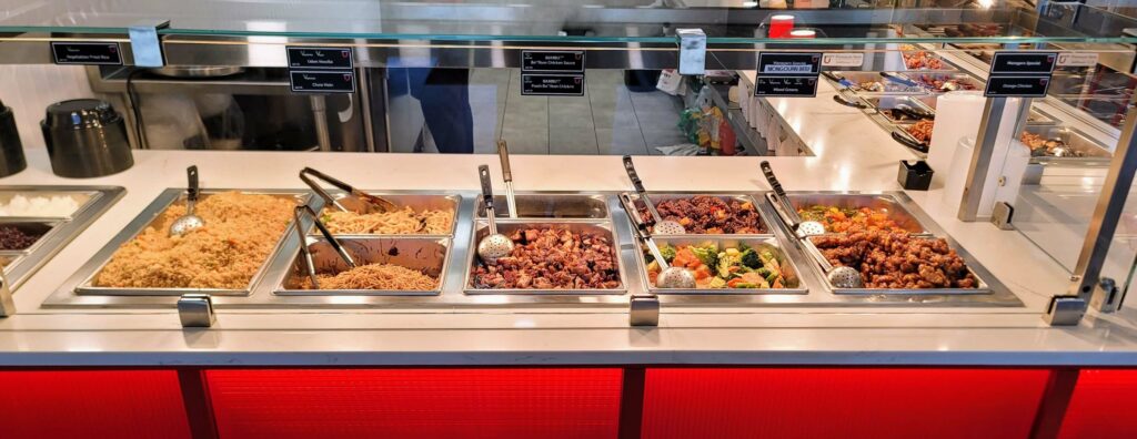 A food bar of different rice, noodle, and protein options at Bambuu Asian Eatery located in Vero Beach florida