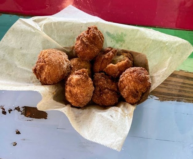Bonuts, a sweet donut hole made from Biscuit dough, rolled in cinnamon and sugar, and topped with honey as served at Island Pig & Fish restaurant located in Fort Pierce Florida