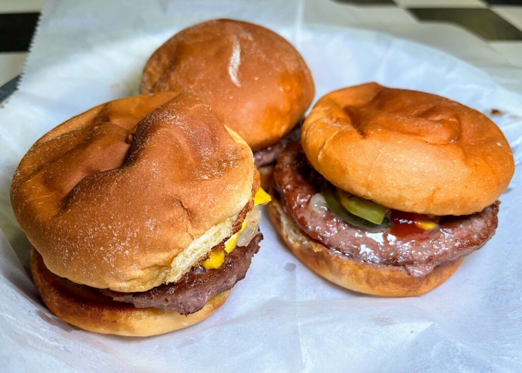 Three beef sliders as served at Mrs Mac's Fillin Station restaurant located in Vero Beach Florida