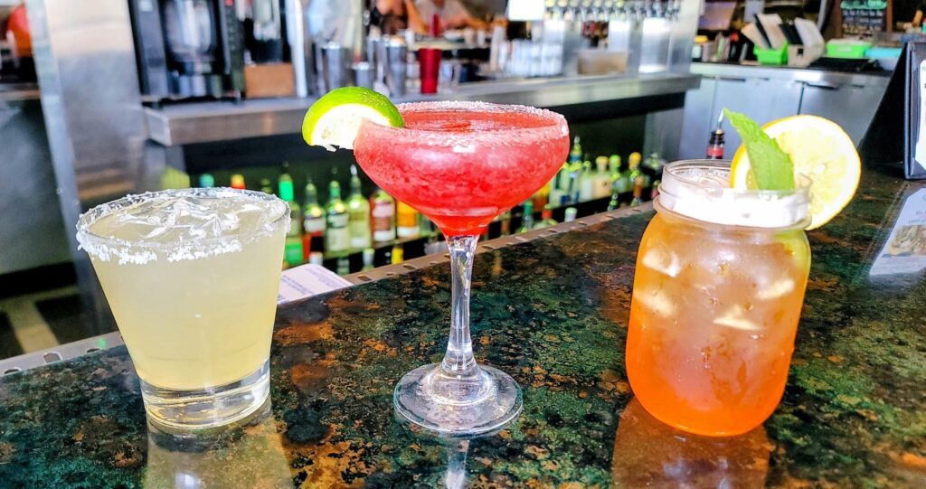 3 cocktails, left to right, house margarita, pomegranate martini, and a bourbon peach tea from Chive restaurant located in vero beach florida