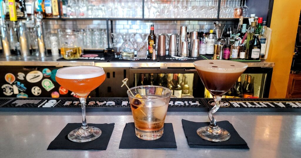 a picture of 3 cocktails, from left to right, For Whom the Tiki Tolls, old fashioned, and their famous espresso martini at Grind & Grape located on the island in vero beach florida