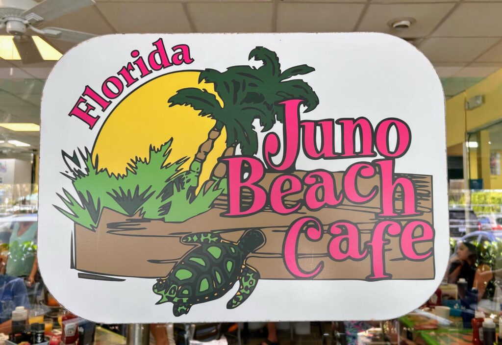 Juno Beach Cafe front door sign at Juno Beach Cafe in Juno Beach Florida