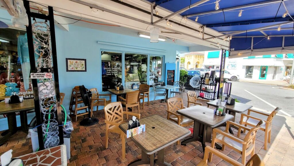outdoor covered patio with tables at Cravings located in vero beach florida