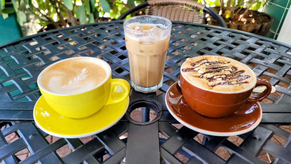 Three seasonal drinks including a pumpkin spice latte, a horchata ice latte, and a smores latte as prepared by Coffee House 1420 located in Vero Beach Florida