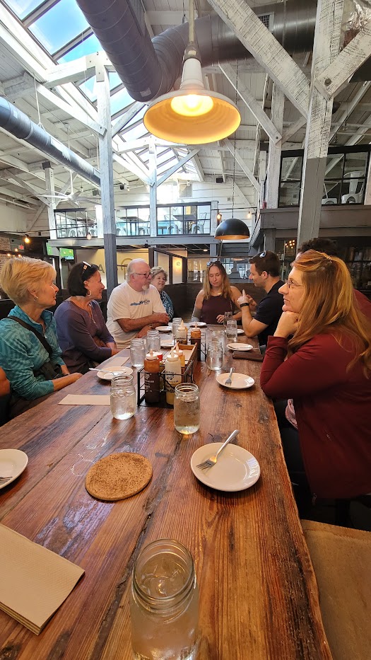 The Charleston Culinary Tour guests sitting at a table enjoying a delicious bite to eat in Charleston South Carolina