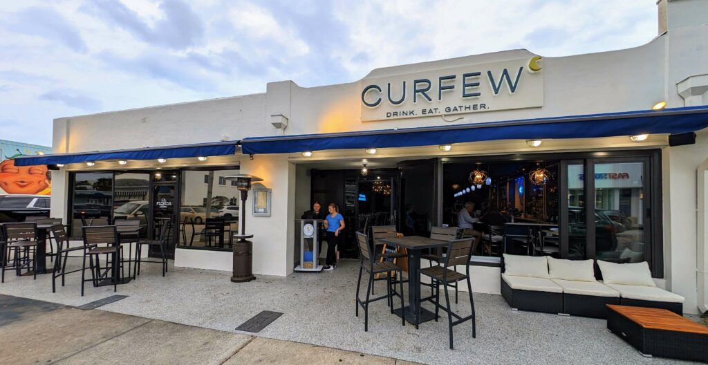 Outside front entrance of Curfew Vero Beach, located in Vero Beach Florida
