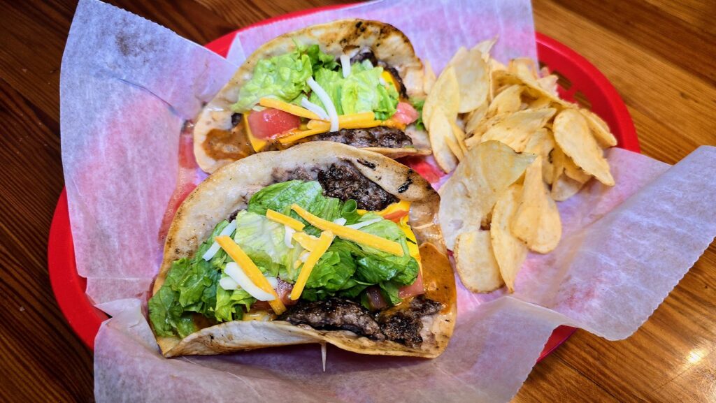 Smash Burger tacos with a side of potato chips as prepared by Malabar Mo's in Malabar, Florida