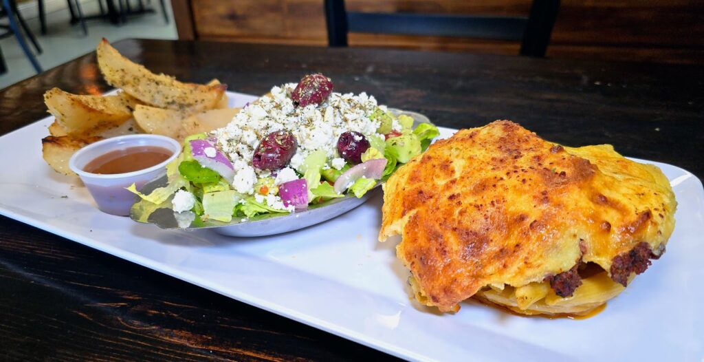 Pastitsio, Greek salad, and Lemon potatoes as prepared by Think Greek PSL located in Port St Lucie Florida