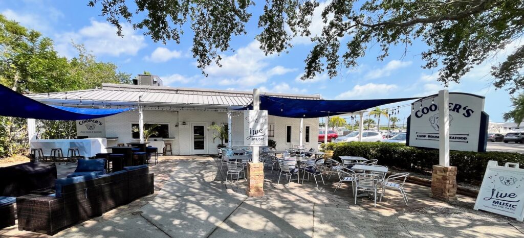The front entrance and al fresco dining at Cooper's Chop House & Seafood located in Royal Palm Pointe in Vero Beach Florida