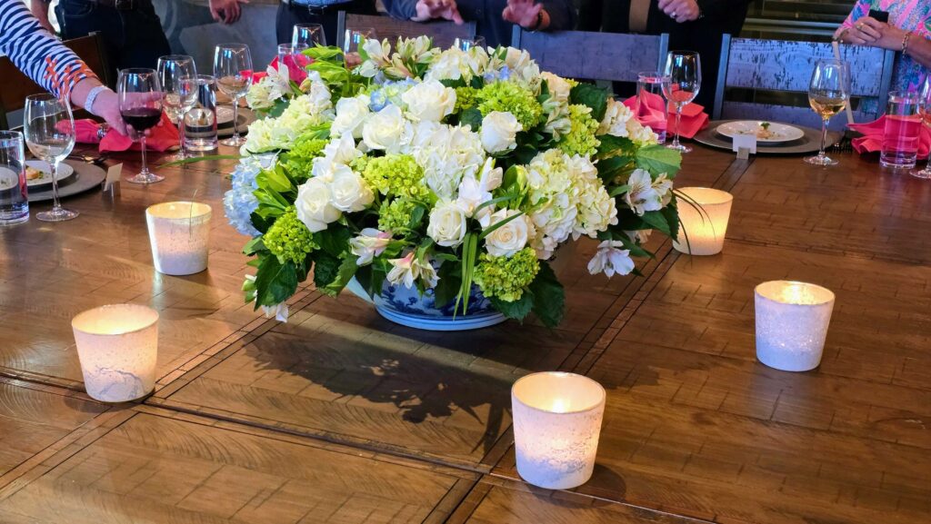 Flower and Candle display on the supper club table inside the Sun Market Sauce Co. in Vero Beach Florida