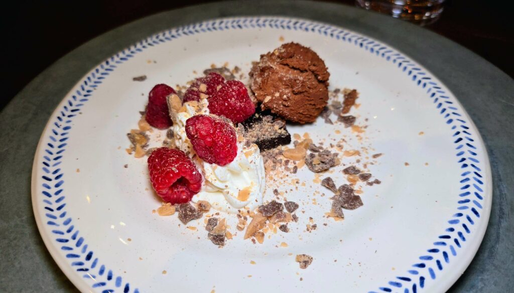 Course Five - “Chocolate Two Ways” was a fabulous mousse (almost like ganache) on a flourless chocolate bottom with a vanilla whipped cream, raspberries, and a toffee crumble as served at the supper club at the Sun Market Sauce Co. in Vero Beach Florida